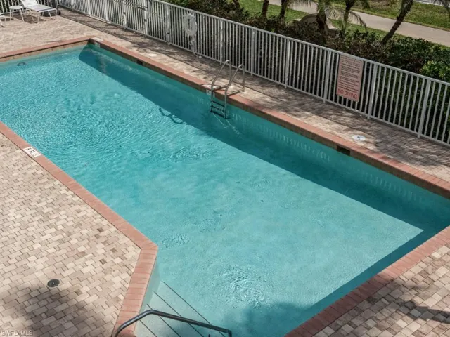 Pool featuring fence and a patio