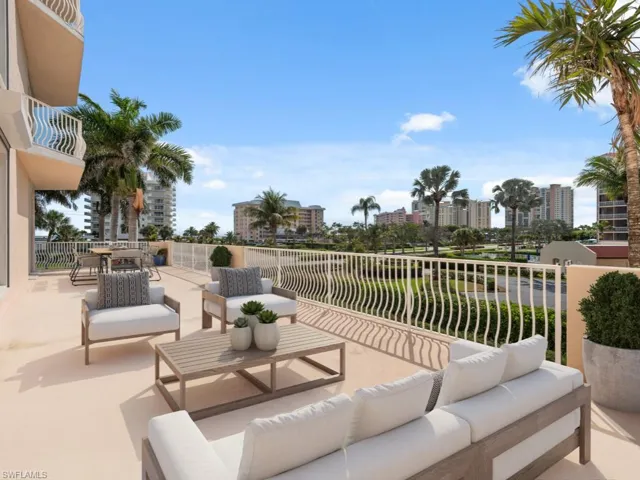 View of patio featuring a balcony, outdoor dining area, an outdoor living space, and a city view