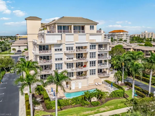 View of building exterior featuring a community pool