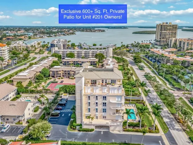 Aerial view featuring a water view and a city view