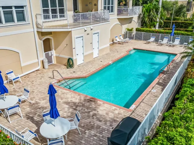 Pool featuring fence and a patio area
