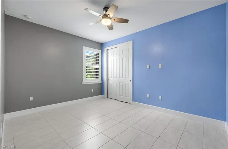 Additional Bedroom with tile-plank flooring and plantation shutters