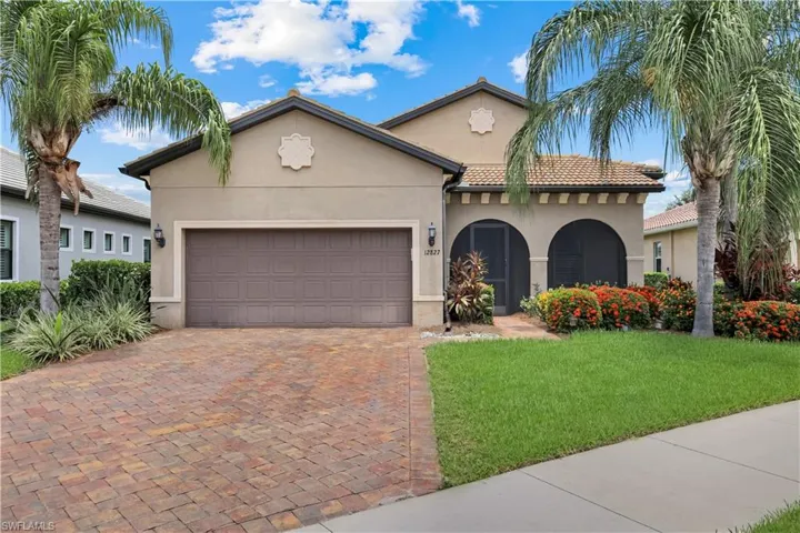 Screened-in Patio at the front door, a tile roof, featuring an arched entryway.