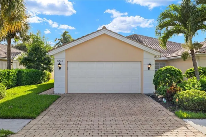 Ranch-style home featuring a garage and a front yard