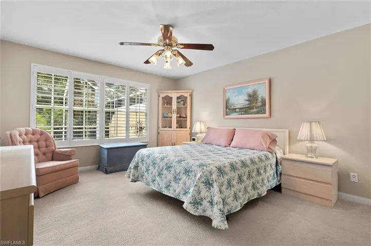 Bedroom featuring light colored carpet and ceiling fan