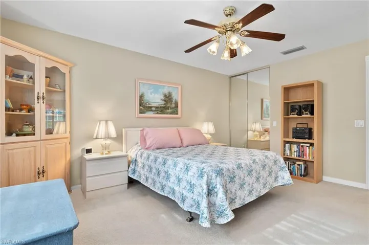 Carpeted bedroom featuring a closet and ceiling fan