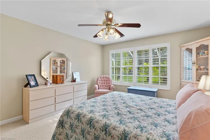 Bedroom with light carpet and ceiling fan