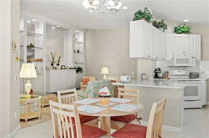 Dining space with a notable chandelier and light tile patterned floors