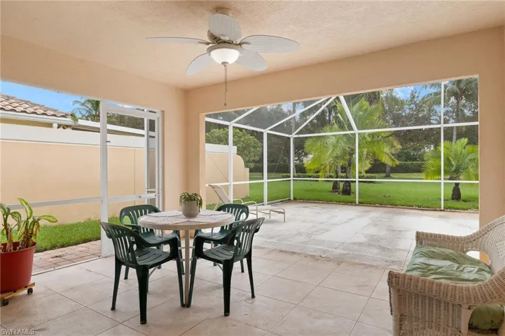 Sunroom / solarium featuring a healthy amount of sunlight and ceiling fan