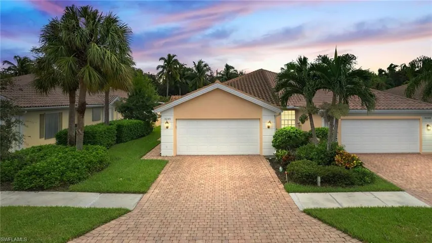 View of front facade featuring a yard and a garage