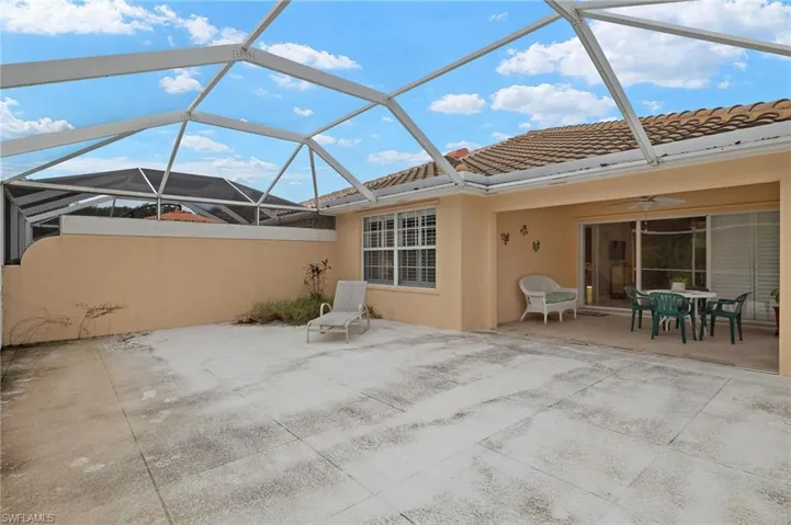 View of patio featuring ceiling fan and a lanai