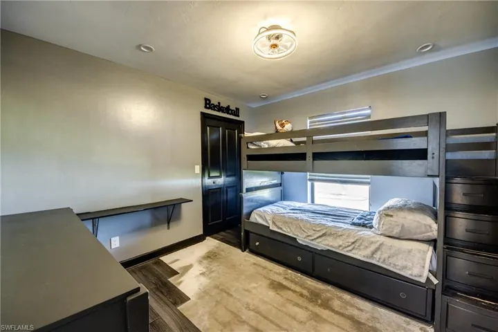 Bedroom featuring wood finished floors and baseboards