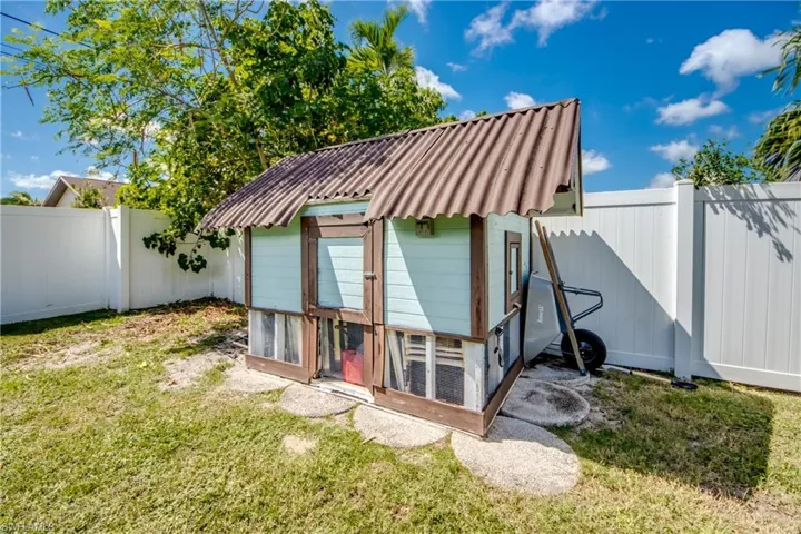 View of poultry coop with a fenced backyard