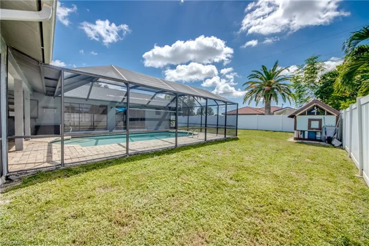 Fenced backyard featuring a lanai, a sunroom, and a patio area