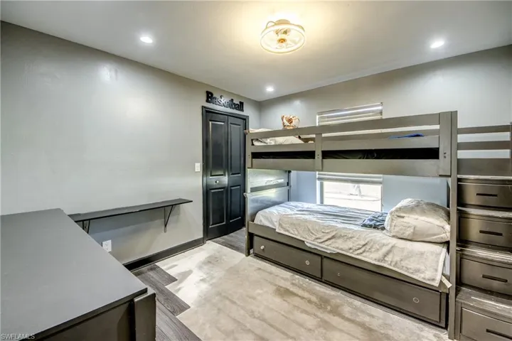 Bedroom with light wood-style flooring, recessed lighting, and a closet