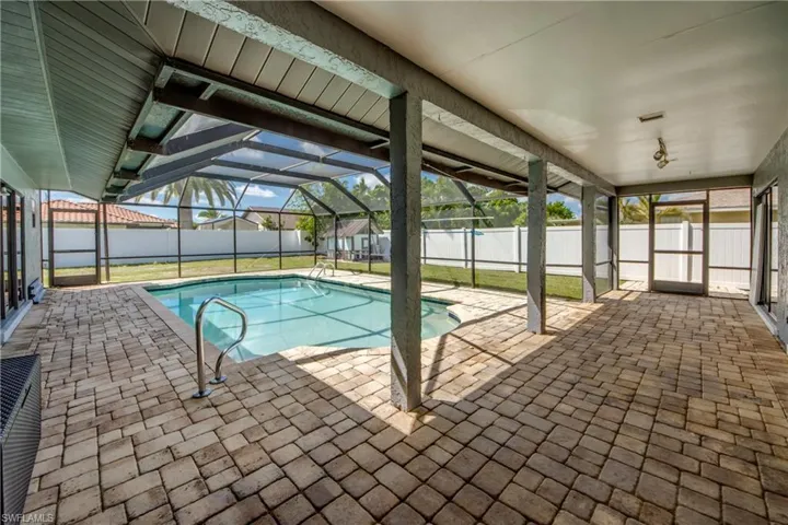 View of swimming pool with a sunroom, a patio area, a lanai, and a fenced backyard