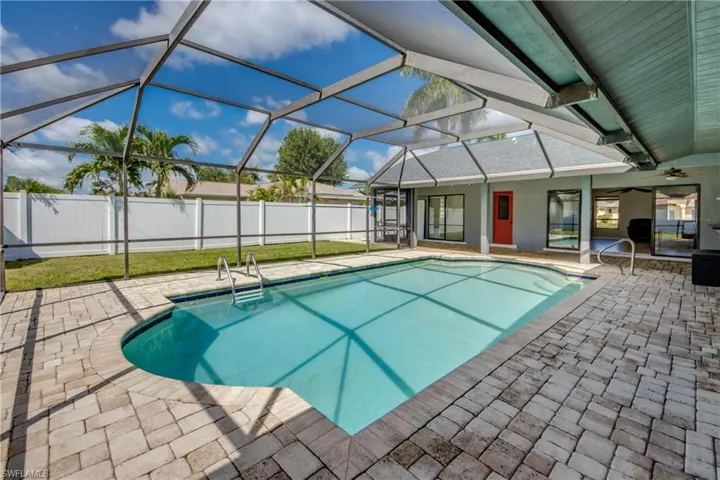 View of pool with a lanai, a patio, a sunroom, and ceiling fan