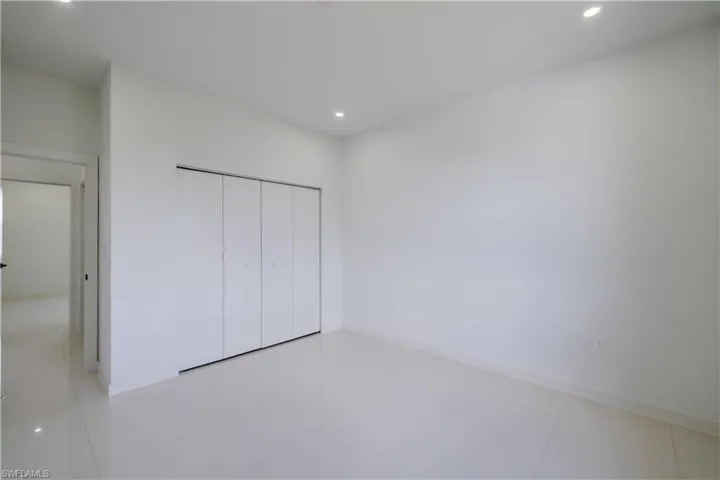 Unfurnished bedroom featuring recessed lighting and a closet