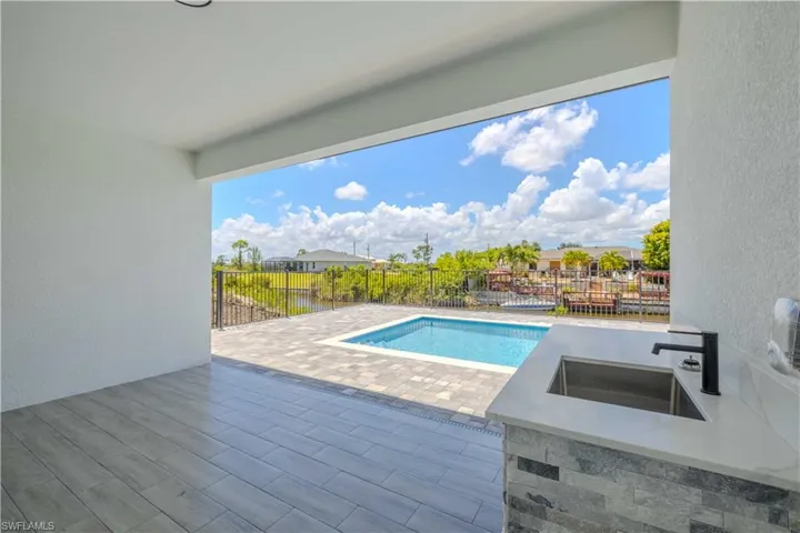 View of swimming pool with a fenced backyard and a patio area