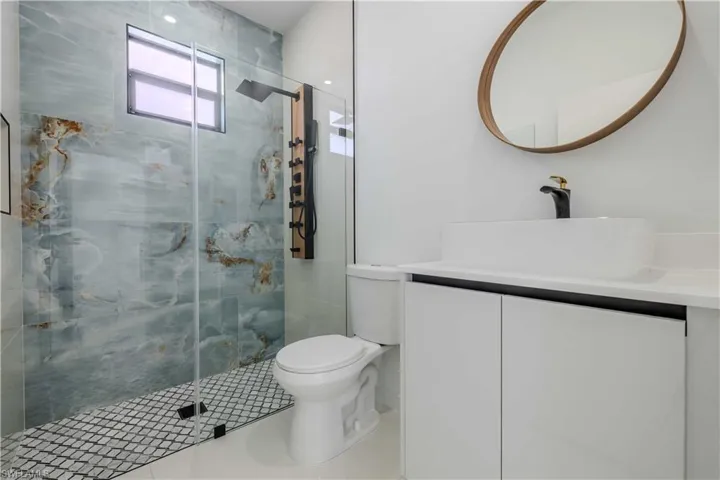 Full bath with vanity and a shower stall