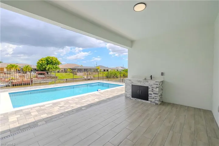 View of swimming pool with a fenced backyard, a patio, and a residential view