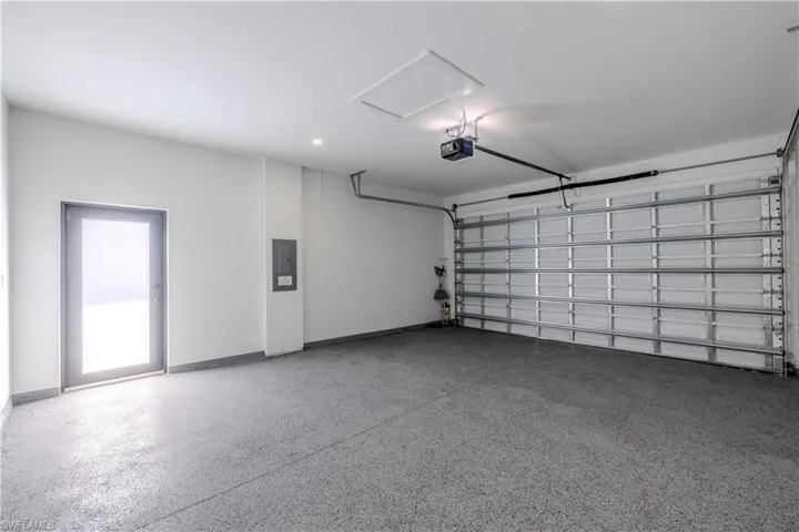 Garage with a garage door opener and electric panel