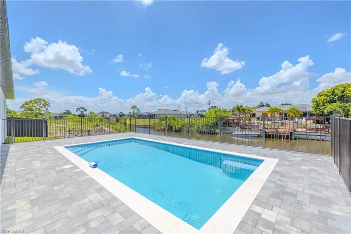 View of pool with a patio and a water view