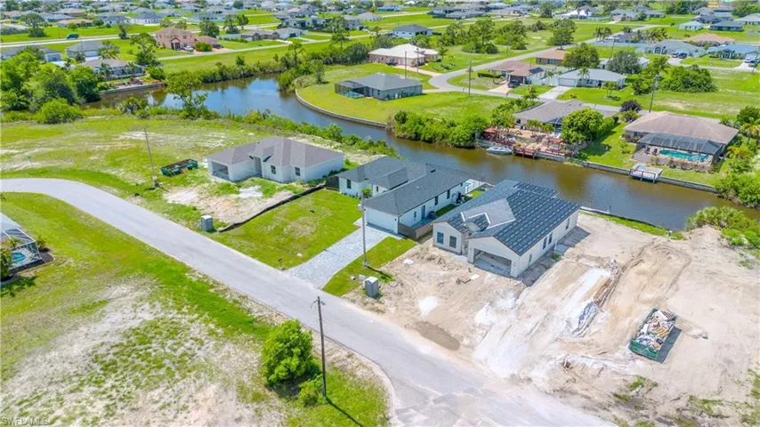 Aerial perspective of suburban area featuring a large body of water