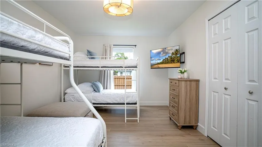 Bedroom with light wood-type flooring and a closet