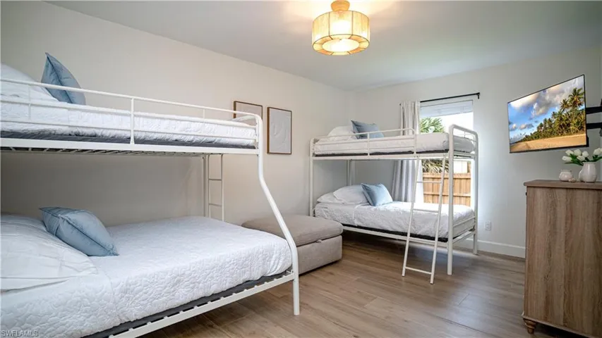 Bedroom featuring light wood-style floors and baseboards