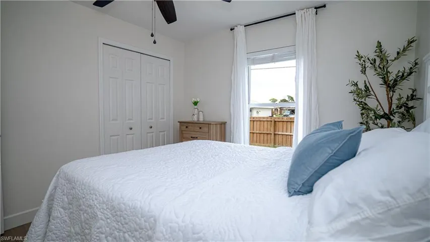 Bedroom with a closet, a ceiling fan, and wood finished floors