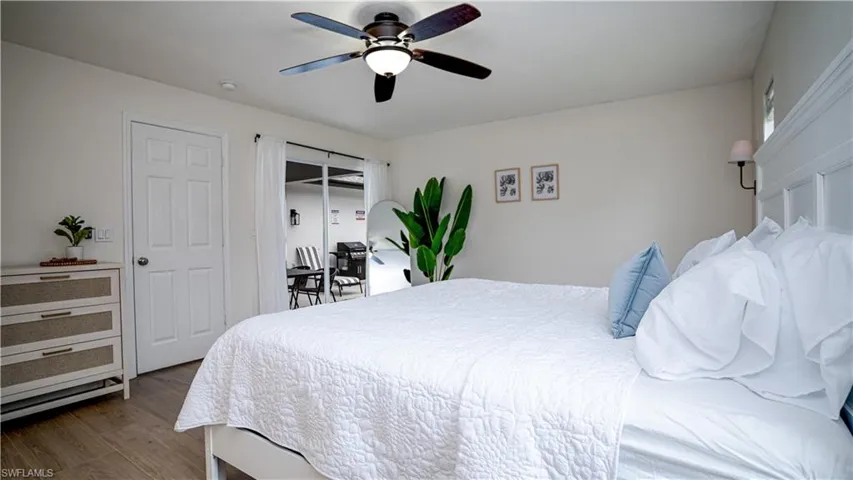 Bedroom with wood finished floors and a ceiling fan