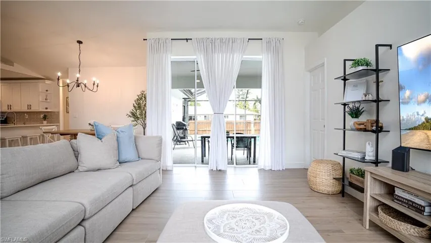 Living area featuring a chandelier and light wood-type flooring