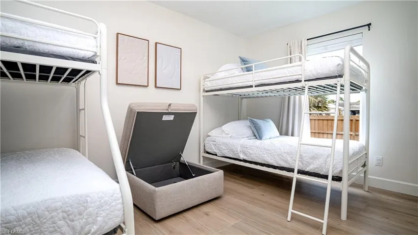 Bedroom with light wood finished floors and baseboards
