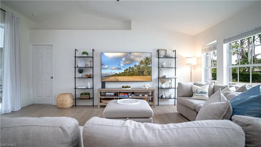 Living area featuring lofted ceiling and wood finished floors