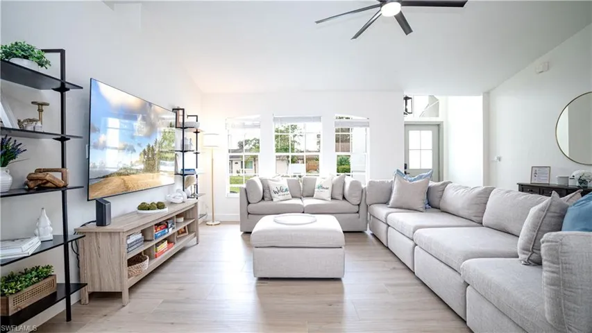 Living area featuring light wood-type flooring and ceiling fan