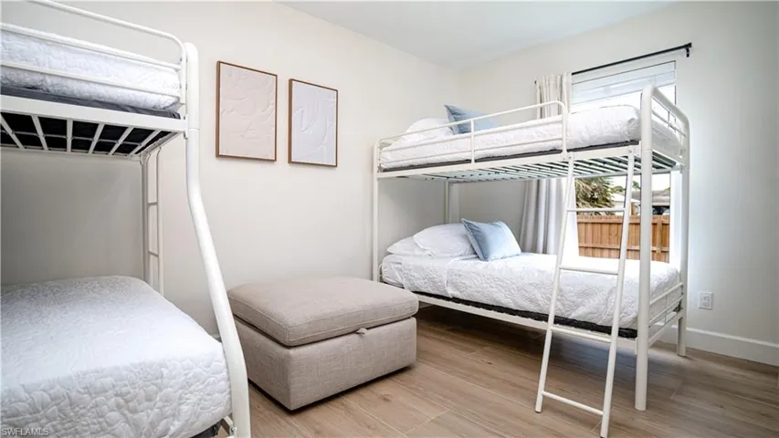 Bedroom featuring light wood-style floors and baseboards