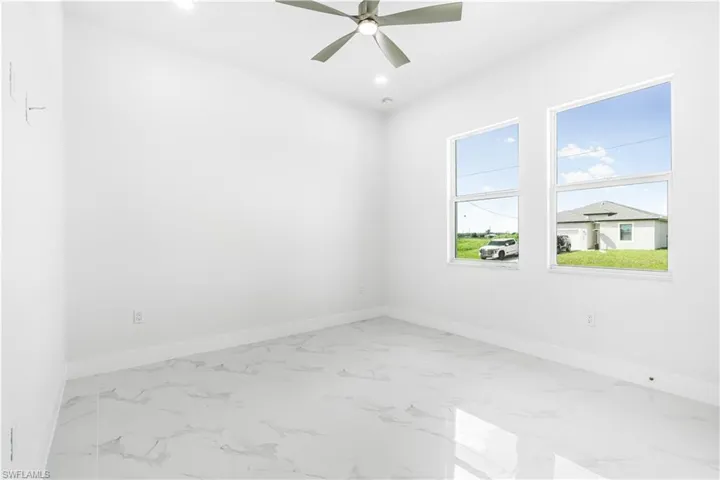 Unfurnished room with tile patterned flooring and ceiling fan