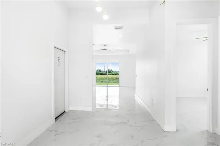 Hallway with tile patterned flooring