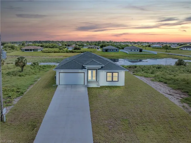 View of front of house featuring a yard and a garage