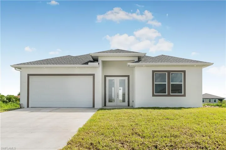 Prairie-style home featuring a garage, french doors, and a front yard