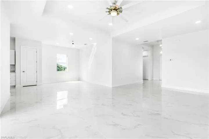 Tiled empty room featuring ceiling fan