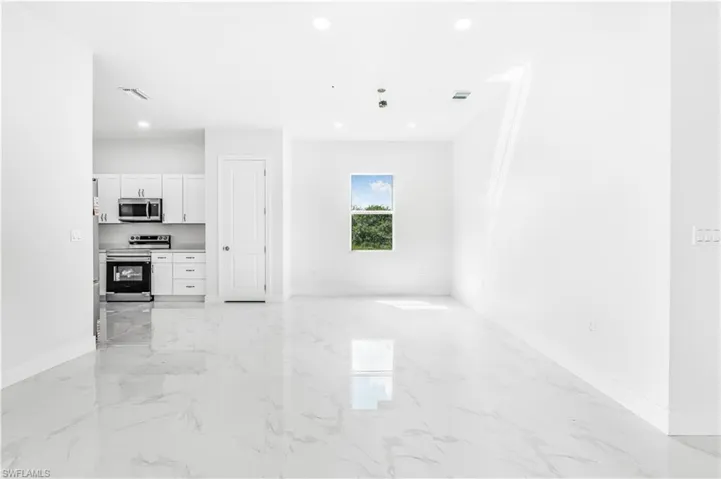Unfurnished living room with light tile patterned floors