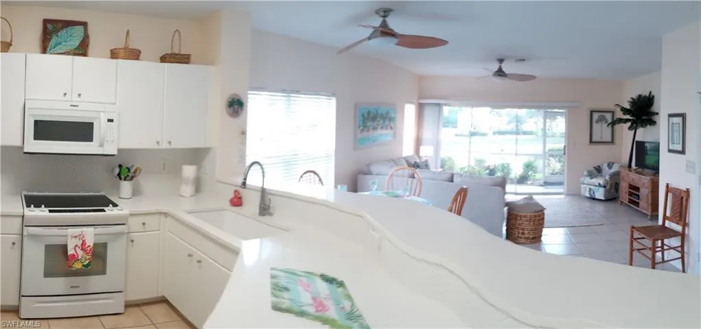 Kitchen to lanai -- beautiful newer Granite Counters with undermount sink