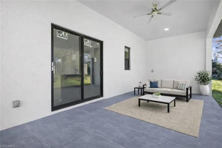 View of patio / terrace with outdoor furniture and a ceiling fan