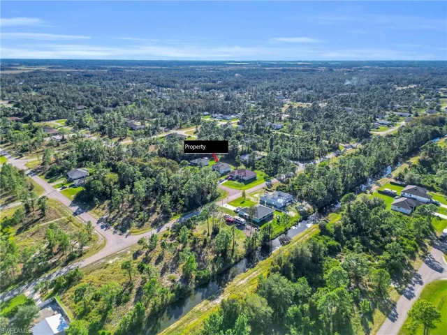 Aerial overview of property's location with a nearby body of water