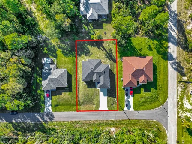 Aerial view of property and surrounding area featuring property boundaries highlighted