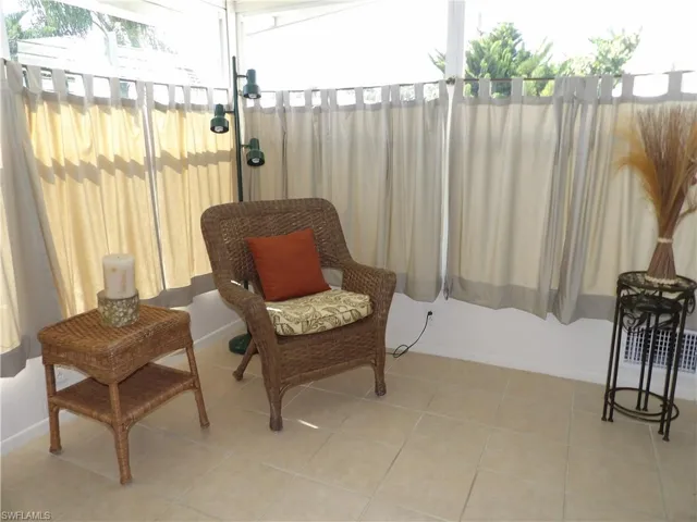 Living area featuring tile patterned flooring and baseboards
