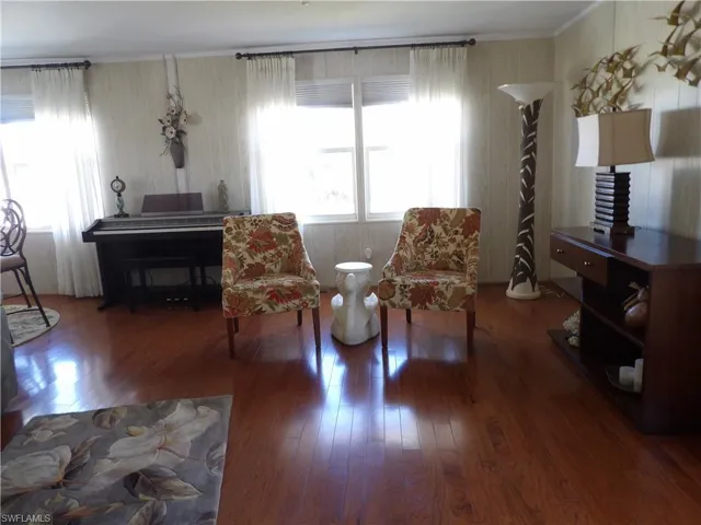 Living area featuring hardwood / wood-style flooring and wooden walls
