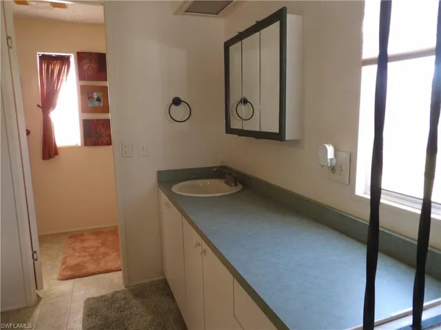 Bathroom featuring plenty of natural light, vanity, and light tile patterned floors